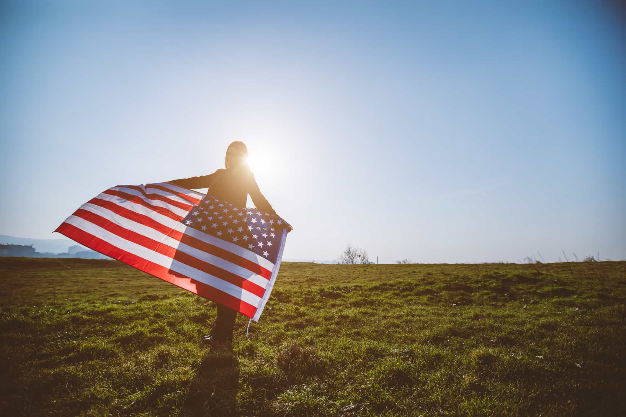 a person holding a flag on a field