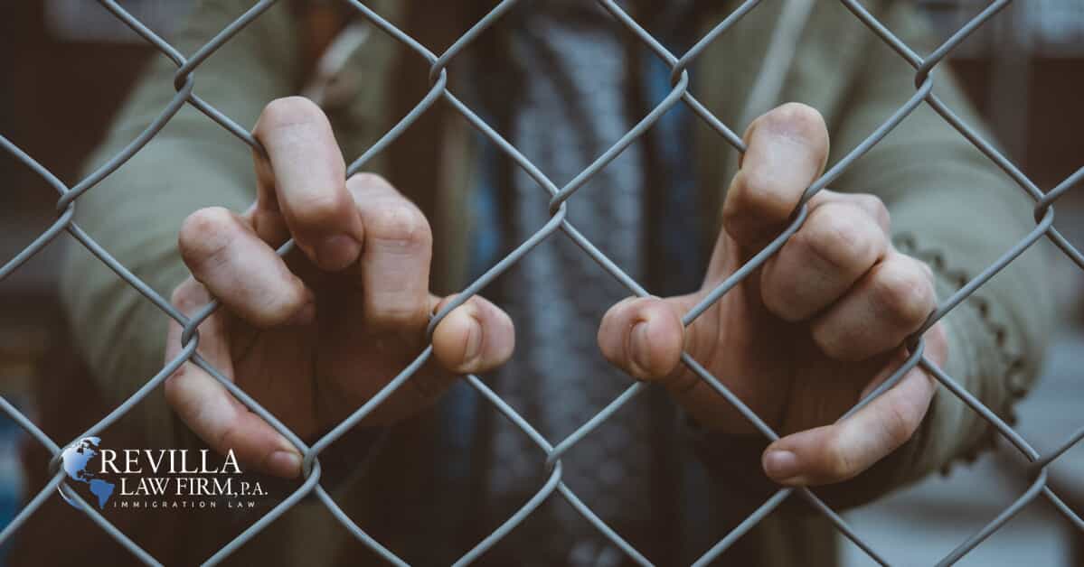 a person holding on to a fence